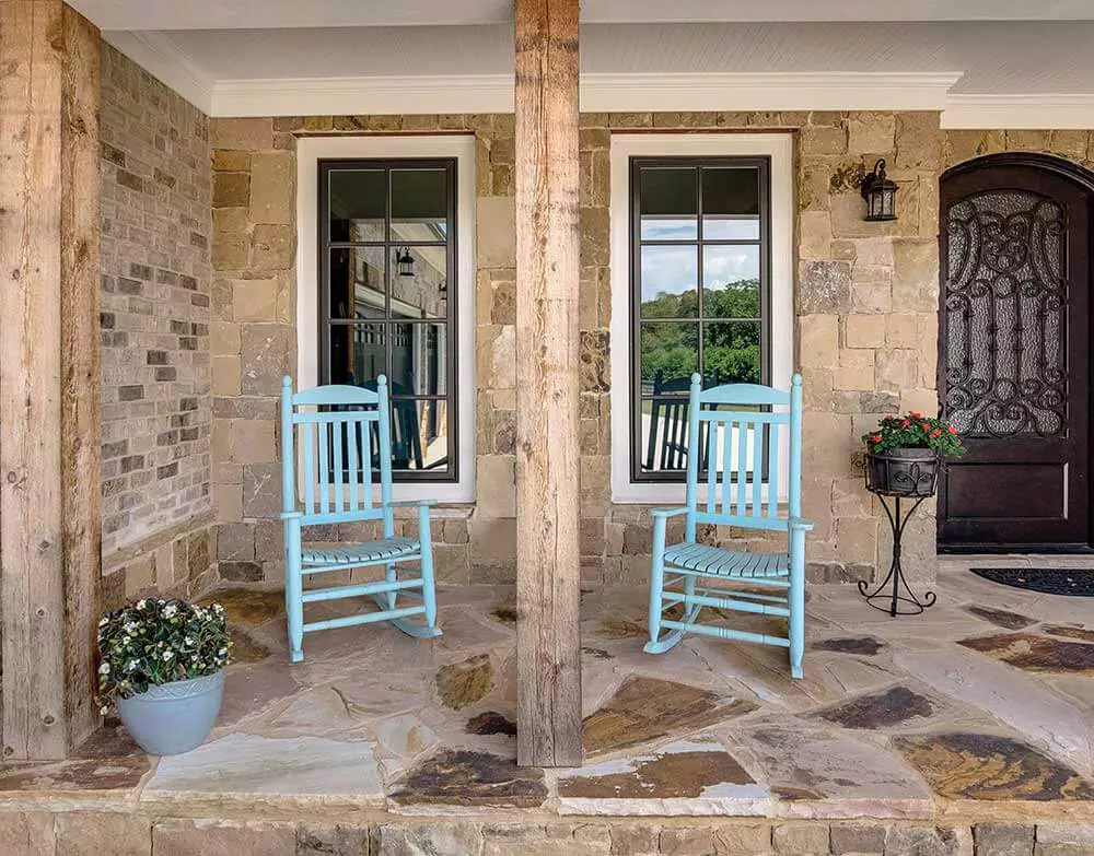 Stone house with white Infinity Replacement Casement Windows